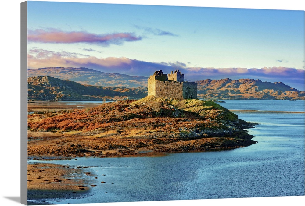 Castle Tioram on the coastal island Eilean Tioram where River Shiel and Loch Moidart meet, at low tide on a sunny winter m...