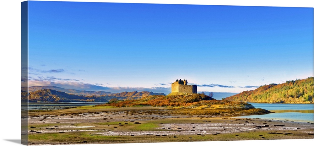 Castle Tioram on the coastal island Eilean Tioram where River Shiel and Loch Moidart meet, at low tide on a sunny winter m...