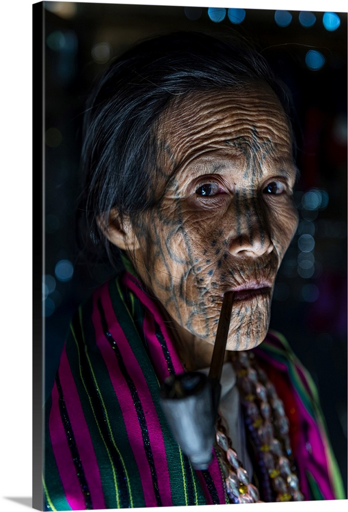 Chin woman with spiderweb tattoo smoking a pipe, Mindat, Chin state, Myanmar (Burma), Asia