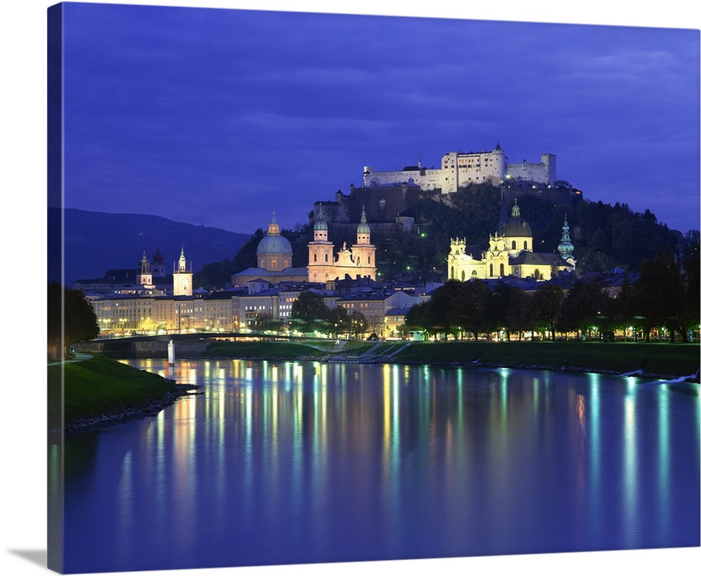 City and castle at night from the river, Salzburg, Austria