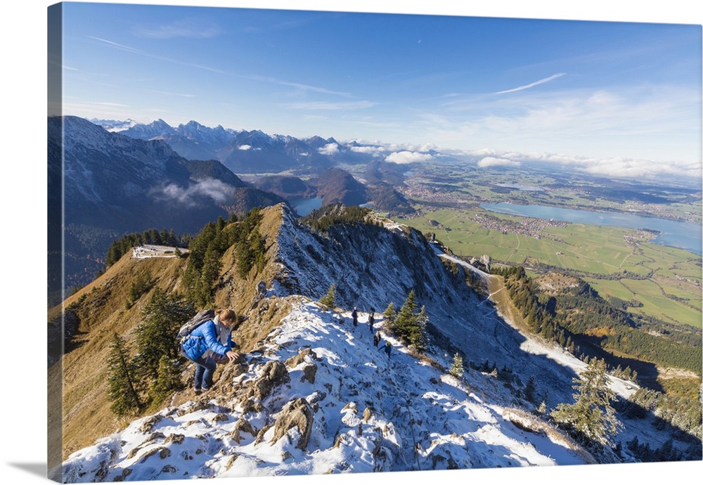 Climbers on steep crest covered with snow in the Ammergau Alps, Tegelberg, Fussen, Bavaria, Germany