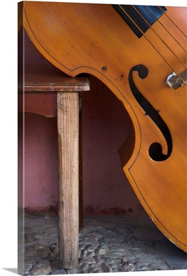 Close-up of a counterbass leaning against a wooden table, Trinidad, Cuba