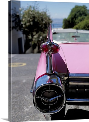 Close-up of fin and lights on a pink Cadillac car