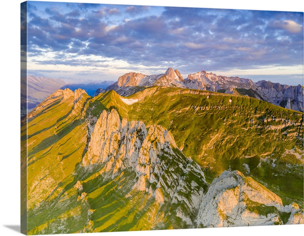 Clouds at dawn over the majestic Santis and Saxer Lucke mountains, aerial view, Appenzell Canton, Alpstein Range, Switzerl...