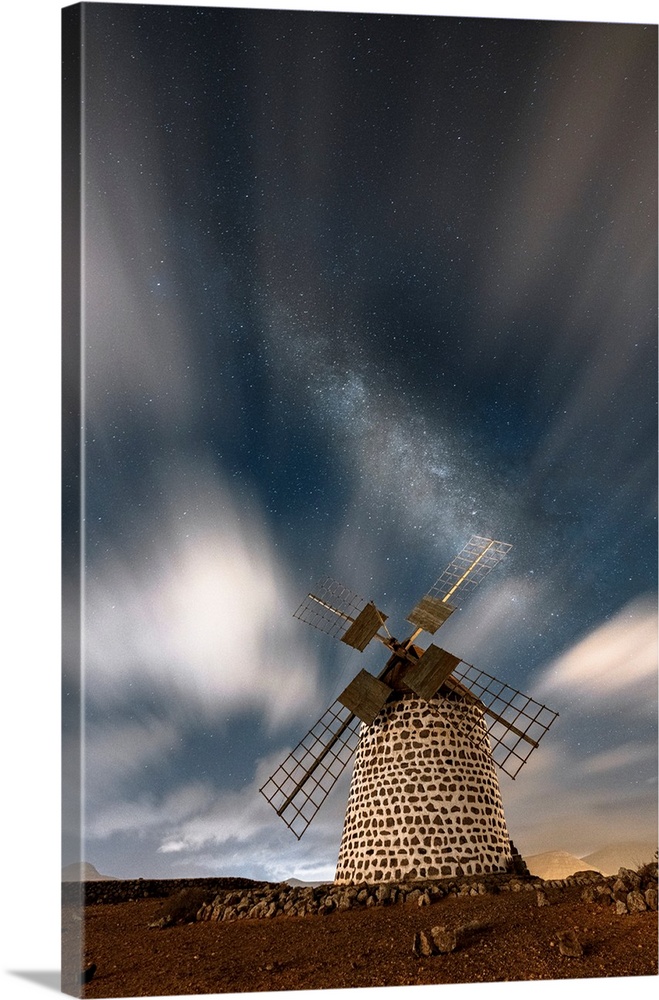 Long exposure image of clouds in the night sky over the old windmill, La Oliva, Fuerteventura, Canary Islands, Spain, Atla...