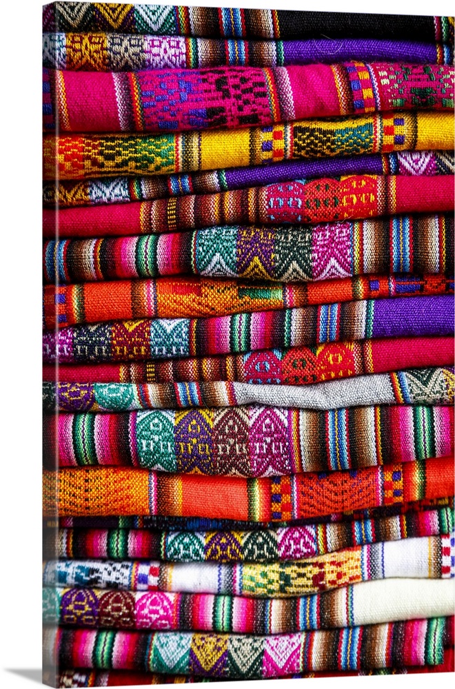 Colorful carpets made of llama and alpaca wool for sale at San Pedro market, Cuzco, Peru.