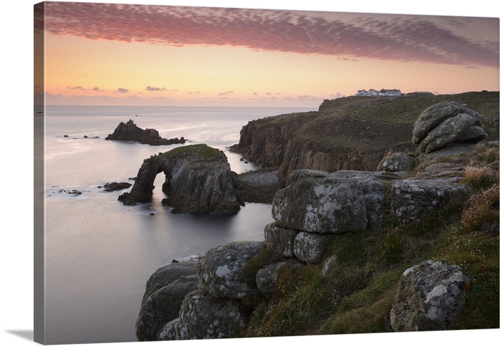 A colourful sunset overlooking the islands of Enys Dodnan and the Armed Knight at Lands End, Cornwall, England
