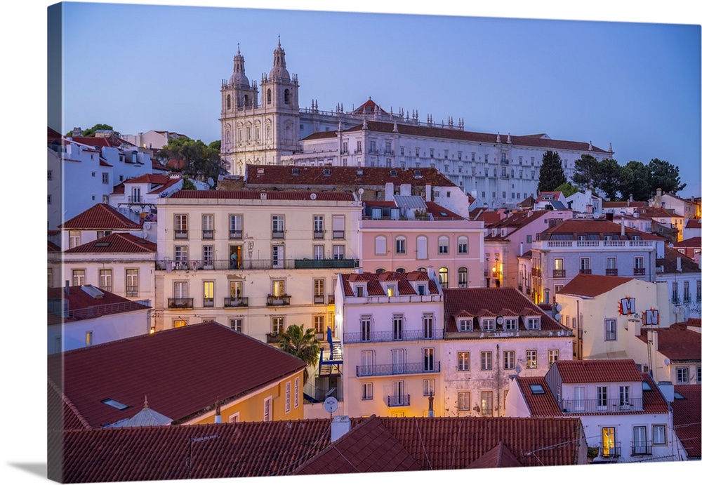 View of colourful buildings and red rooftops at dusk in the Alfama District, Lisbon, Portugal, Europe