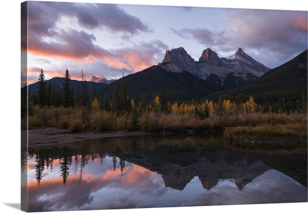 Colourful sunrise over Three Sisters at Policeman Creek in autumn, Canmore, Banff, Alberta, Canadian Rockies, Canada, Nort...