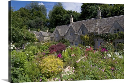 Cotswold stone cottages with colourful flower gardens, Cotswolds, England