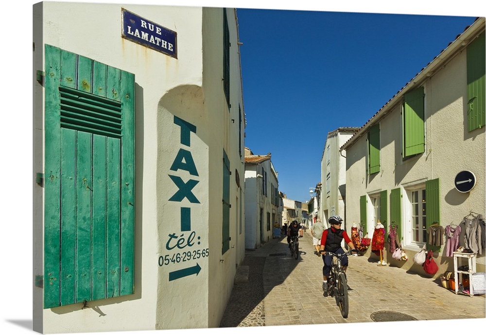 Cyclist on Rue Lamathe in the island's principal western town, Ars en Re, Ile de Re, Charente-Maritime, France