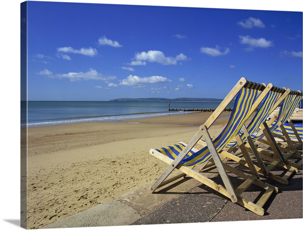 Deckchairs on the Promenade overlooking deserted beach, Dorset, England