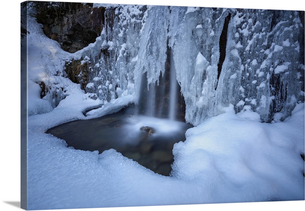 Details of a waterfall framed by ice and snow, Switzerland, Europe