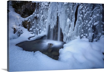 Details of a waterfall framed by ice and snow, Switzerland