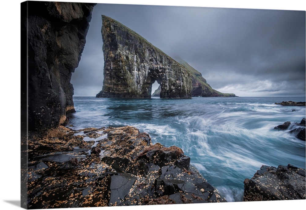 Dramatic Sea Arch of Drangarnir and waves crashing on the Faroe Islands coast, Faroe Islands, Denmark, Atlantic, Europe