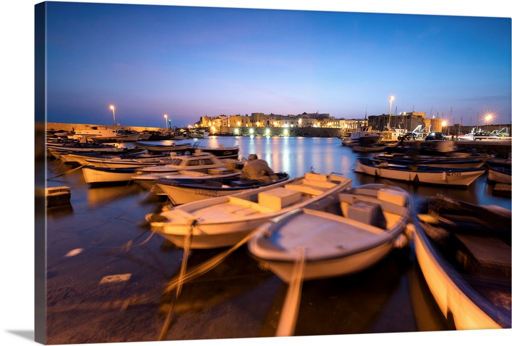 Dusk lights the harbor and the medieval old town of Gallipoli, Province of Lecce, Apulia, Italy