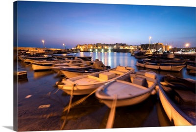 Dusk lights the harbor and the medieval old town of Gallipoli, Apulia, Italy