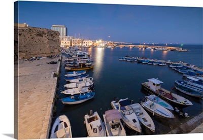 Dusk lights the harbor and the medieval old town of Gallipoli, Province of Lecce, Italy