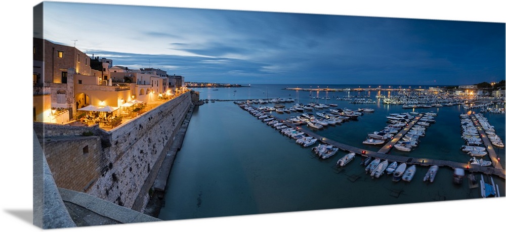 Dusk lights the harbor and the medieval old town of Otranto, Province of Lecce, Apulia, Italy