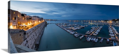 Dusk lights the harbor and the medieval old town of Otranto, Province of Lecce, Italy