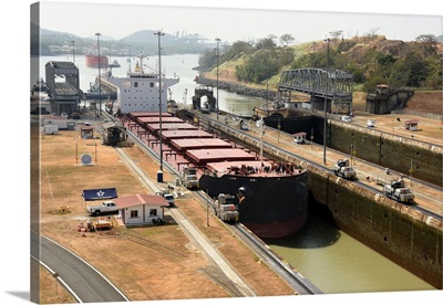 Electric mules guiding Panamax ship through Miraflores Locks on the Panama Canal, Panama