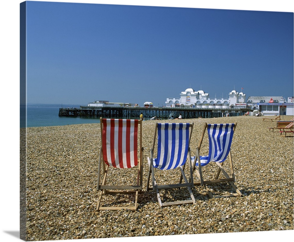 Empty deck chairs on the beach and the Southsea Pier, Hampshire, England