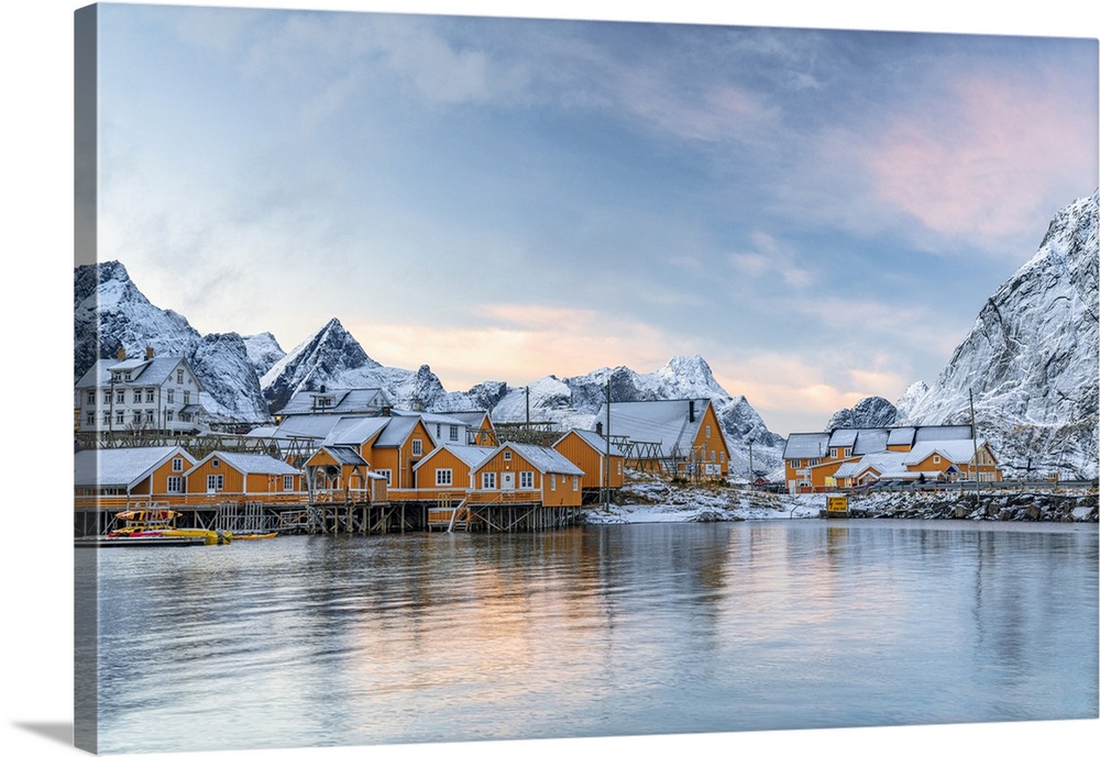 Fishermen's wood cabins covered with snow at sunset in the tiny village of Sakrisoy, Reine, Nordland, Lofoten Islands, Nor...