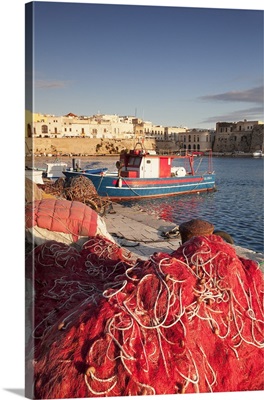 Fishing boats and fishing net at the port, old town, Gallipoli, Puglia, Italy