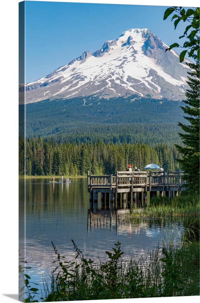 Fishing on Trillium Lake with Mount Hood, part of the Cascade Range, reflected in the still waters, Oregon