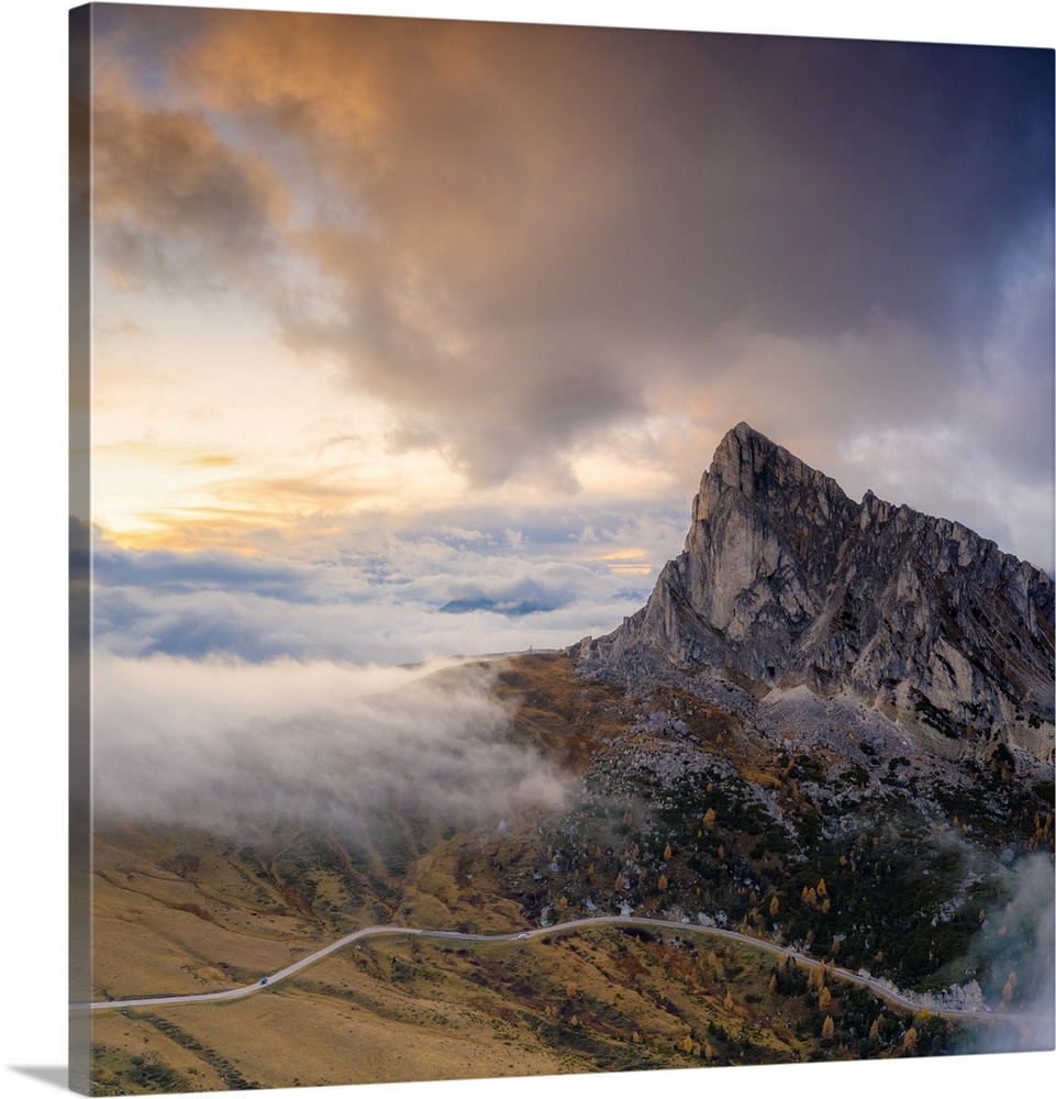 Aerial view by drone of foggy sky at sunset over Ra Gusela and Giau Pass in autumn, Dolomites, Belluno, Veneto, Italy, Europe
