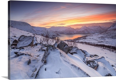 Frozen sea surrounded by snow at sunset, Torsken, Senja, Troms County, Norway