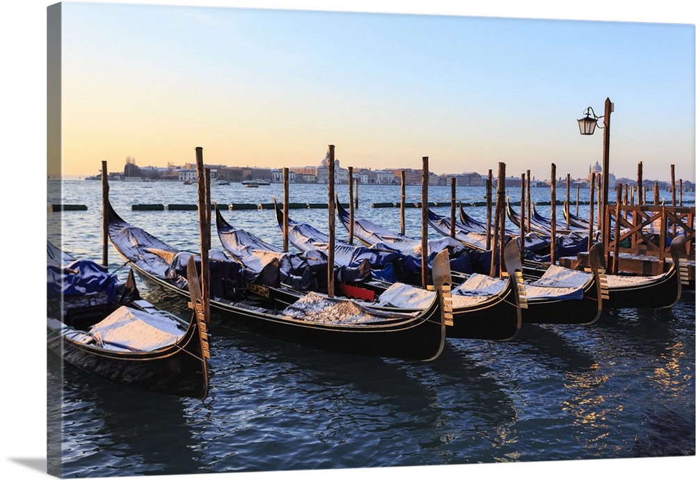 Gondolas covered in snow with view to La Guidecca, sunrise, Venice, Veneto, Italy