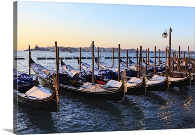 Gondolas covered in snow with view to La Guidecca, sunrise, Venice, Veneto, Italy