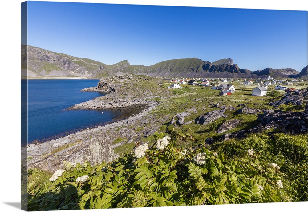 Green meadows frame the village of Sorland surrounded by sea, Vaeroy Island, Nordland county, Lofoten archipelago, Norway,...