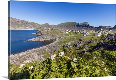Green meadows frame the village of Sorland surrounded by sea, Norway