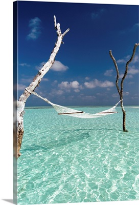 Hammock over the waters of a tropical lagoon, The Maldives, Indian Ocean