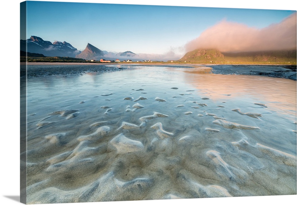 High peaks and midnight sun are reflected in the cold sea, Fredvang, Moskenesoya, Nordland county, Lofoten Islands, Norway...