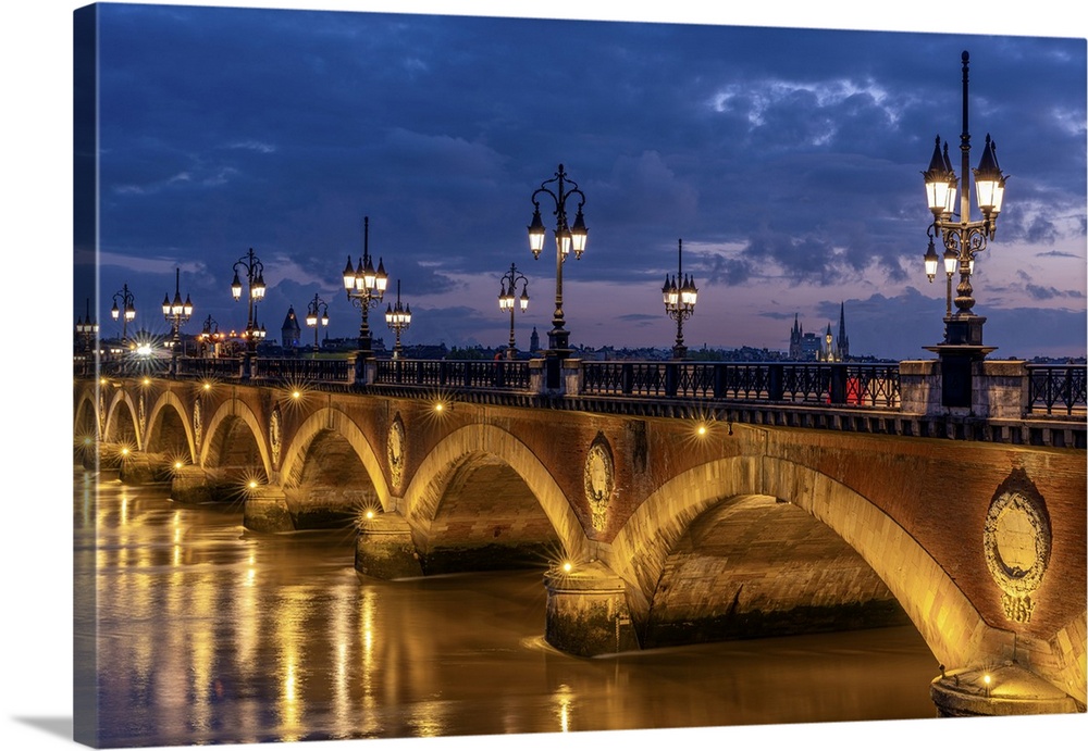 Historic bridge, Pont de Pierre over the Garonne River at blue hour (dusk), Bordeaux, Gironde, Nouvelle-Aquitaine, France,...