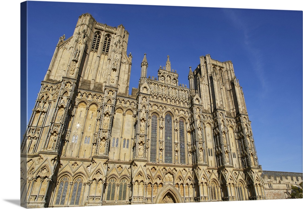 The historic western facade of Wells Cathedral, with its twin square towers, in Wells, Somerset, England, United Kingdom, ...
