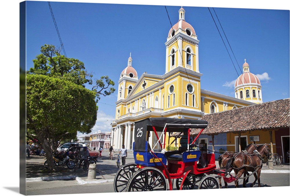 Horse cart passing Cathedral de Granada, Park Colon, Granada, Nicaragua