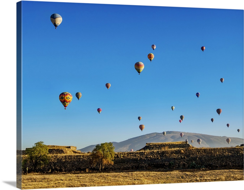 Hot air balloons flying over the Teotihuacan Archaeological Site at sunrise, Mexico State, Mexico