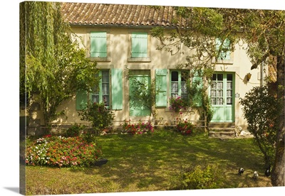 House with typical regional green shutters in the Marais Poitevin wetlands, France