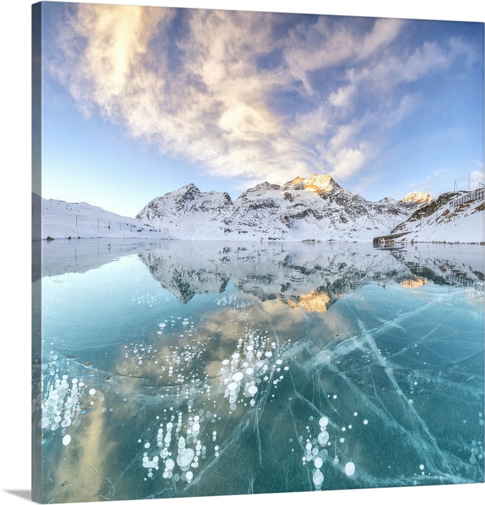 Panorama of ice bubbles and frozen surface of Lago Bianco at dawn, Bernina Pass, canton of Graubunden, Engadine, Switzerland