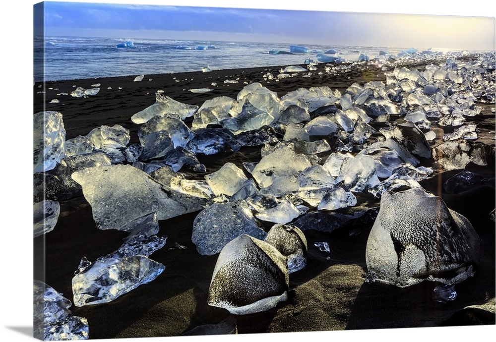 Icebergs on a black sand volcanic beach next to the Jokulsarlon glacial lake in Vatnajokull National Park in southeast Ice...