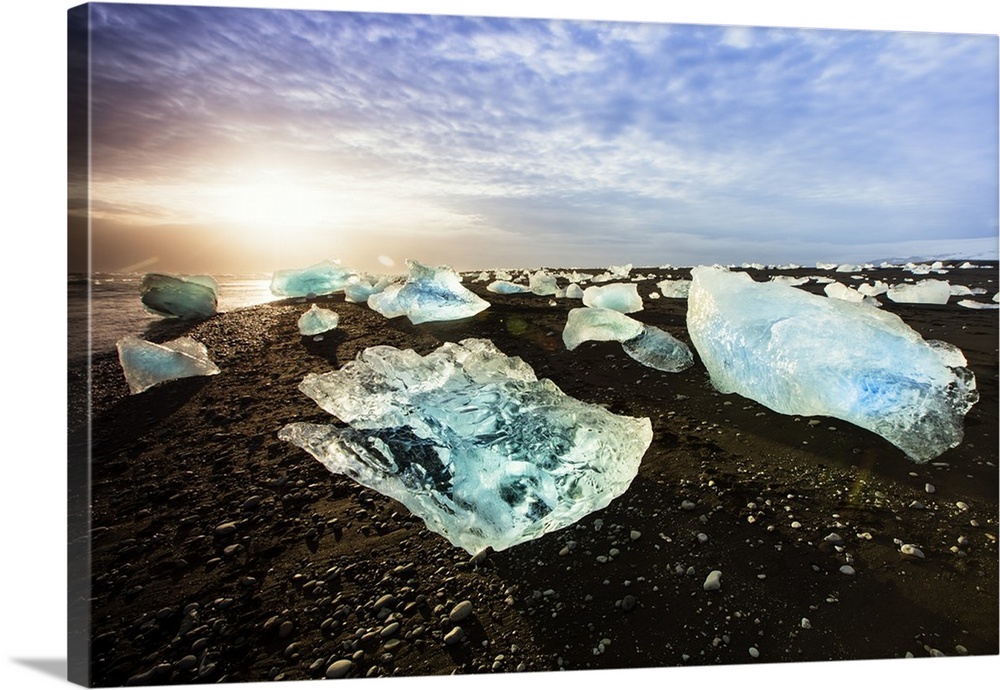 Icebergs on a black sand volcanic beach next to the Jokulsarlon glacial lake in Vatnajokull National Park in southeast Ice...