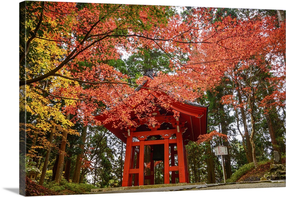 Iconic red Shoro (bell tower) framed by vivid autumn leaves on Mount Hiei, near the historic Enryaku-ji Temple, Ohara, Hon...