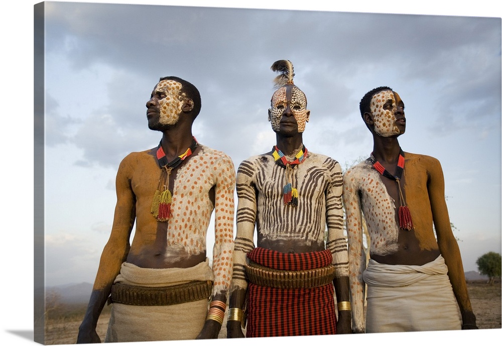 Karo tribesmen with face and body painting imitating the spotted plumage of the guinea fowl, Omo river, Lower Omo Valley, ...