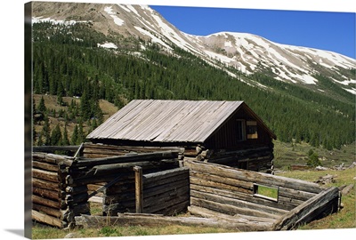 Log cabin at Independence town site, with Sawatch Mountains, Colorado, USA