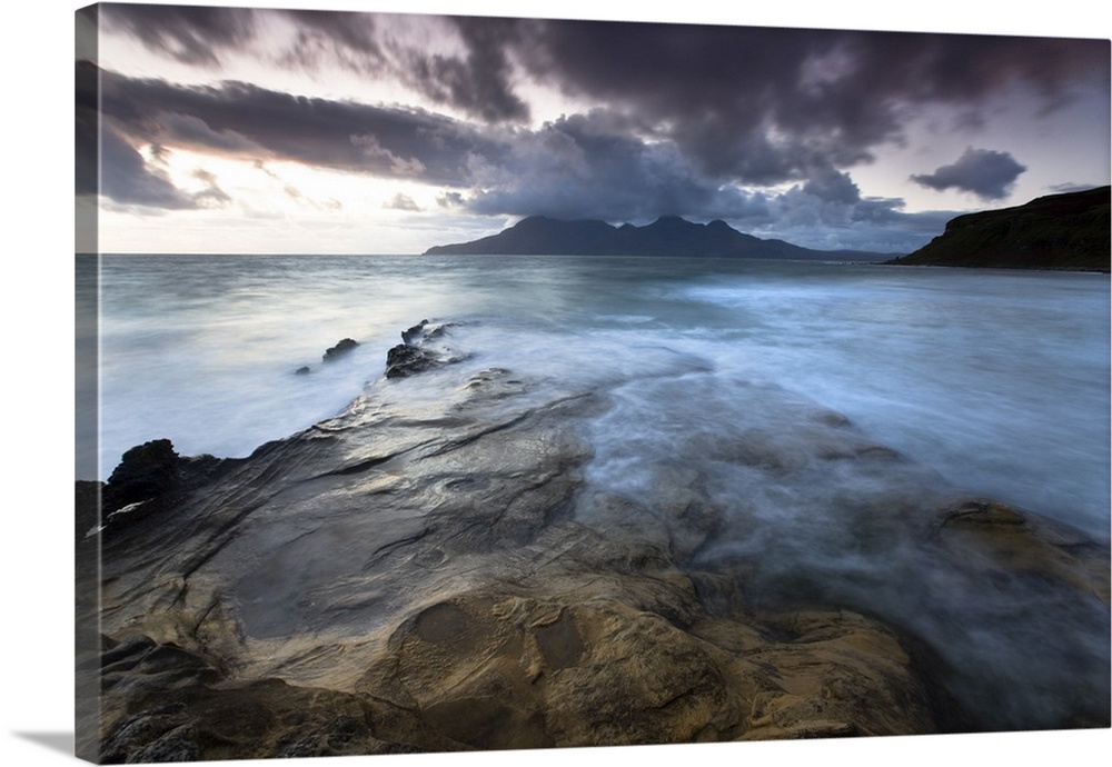 Looking towards Isle of Rum at twilight from rocks at Singing Sands , Isle of Eigg, Scotland