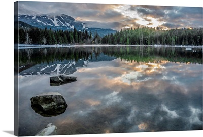 Lost Lake, so still it gives a reflection of the sunset, ski hill and surrounding forest